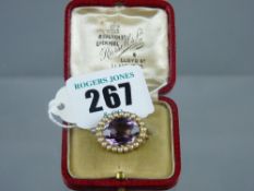 A fifteen carat gold oval amethyst and seed pearl brooch, 3.5 grms in original Russell Ltd,