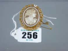 A fifteen carat gold frame oval lady cameo brooch, the frame of scrolled and ball filigree