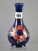 A Moorcroft 'Anemone' cobalt blue narrow necked bottle vase, impressed marks, 16 cms high