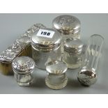 A parcel of seven silver topped/banded glass dressing table containers and a silver topped oblong