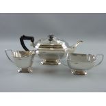 A heavy three piece silver tea service of plain oblong form, each piece on a stepped pedestal, 38