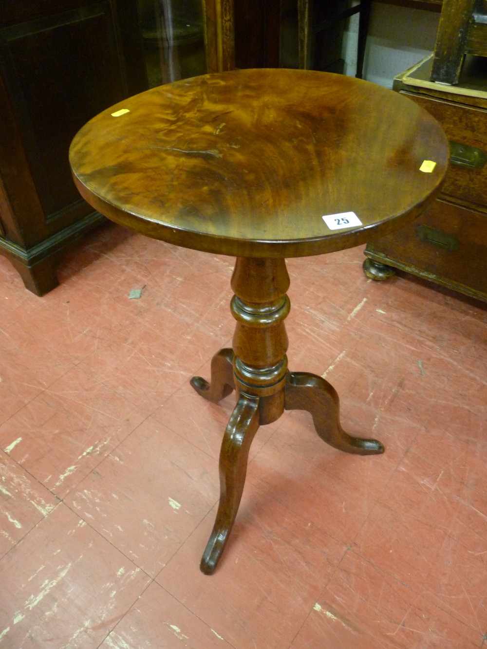 An early Victorian circular mahogany tripod coffee table having a well shaped turned and tapered