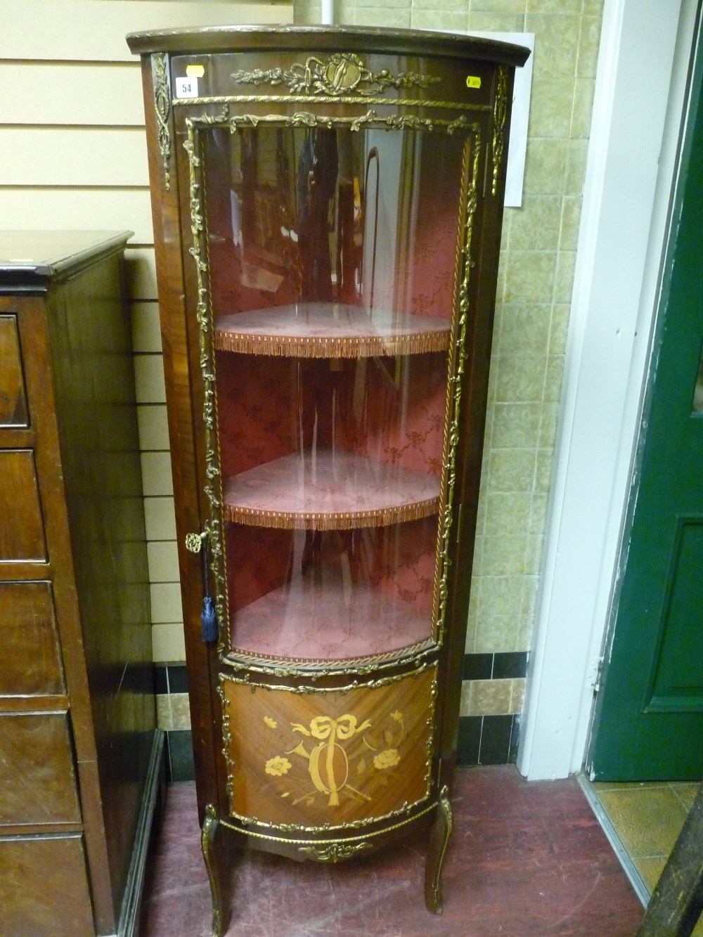 A reproduction French style Kingwood and brass embellished corner cabinet with tulip wood inlay to