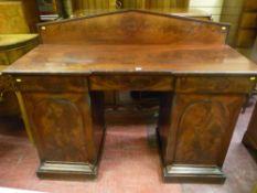 A 19th Century mahogany twin pedestal sideboard with raised back panel, inverted breakfront top with