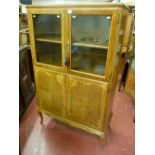 A 20th Century French style walnut cabinet of two glazed doors over two inlaid bottom doors with