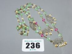 A white metal filigree necklace decorated seed pearls and delicate double point green and pink