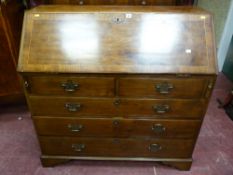 A late Georgian mahogany fall front bureau with a well fitted interior arrangement of drawers and