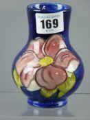 A Moorcroft pottery 'Clematis' blue ground vase, impressed factory marks, 11 cms high