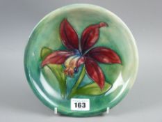 A Moorcroft pottery 'Orchid (Laelia Autumnolis)' plate, 18.5 cms diameter, painted and impressed