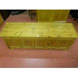 A stripped pine dower chest having five front inset and moulded panels, 139 cms wide