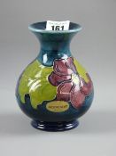 A Moorcroft pottery 'Clematis' vase with applied paper label and impressed factory marks to the