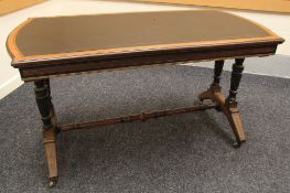 A carved Victorian ebonised and gilded library table with shaped top with black leather insert,