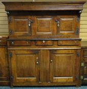 An oak deuddarn, the base with two cupboards and three drawers, the top with two cupboards, circa