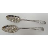 A pair of George III silver berry-spoons having incise decoration and raised fruit to the bowls,