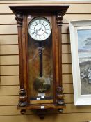 A walnut encased Vienna wall clock of architectural-form with the circular ivorine dial bearing