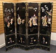 A reproduction Japanese lacquer four-fold screen, typically decorated with raised figures etc,
