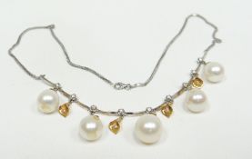 An 18ct yellow and white gold diamond necklace with five pear-shaped freshwater pearl drops, 21gms