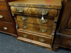 A small mahogany empire-style chest of four graduated drawers (distressed)