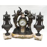 A French spelter and pink marble clock garniture. With two dancing cherubs flanking the raised