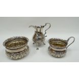 A silver cream jug and matching sugar basin having continuous raised acanthus decoration to the body