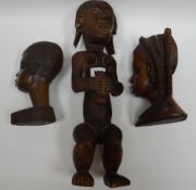 A carved native Fang-tribe style seated figure and a pair of African carved native busts
