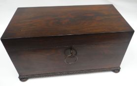 A George IV large rosewood tea-caddy of plain box-form on bun feet with beaded lower border and