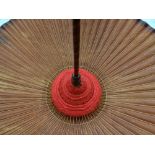 An early-twentieth century Oriental parasol with burnt-bamboo shaft and wooden handle and with