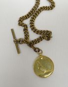 An 18ct yellow gold pigeon-racer medal, dated 1932, 12gms; attached to a yellow metal muff-type