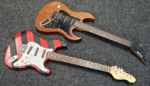 A red and black stripe Encore electric guitar and an all-wood Rocket Special electric guitar