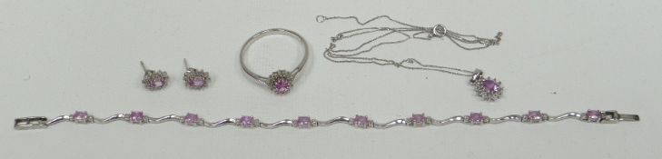 A suite of pink stone and diamond jewellery comprising necklace, cluster ring and matching earrings