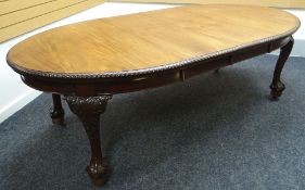 A mahogany oval wind-out dining table with gadrooned border and carved ball and claw feet, circa