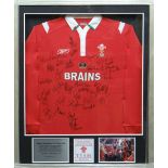A framed Welsh Rugby Union home jersey by Reebok, signed by thirty-four of the ground-breaking