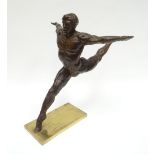 A bronze sculpture of Mikhail Baryshnikov in arabesque position mounted to a bronze platform base,