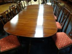 A fine set of twelve (10+2) Chippendale style mahogany dining chairs with matching upholstered