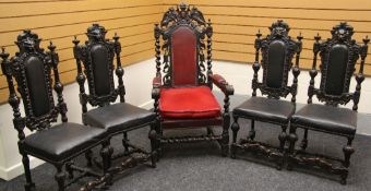 A set of four heavily carved dining chairs, having lion mask finials and leatherette seats, together