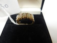 A 9ct yellow gold ring set with five opals, 2.2gms