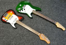 A green and white Tanglewood electric guitar and a brown and white Jedson electric guitar