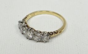 An 18ct yellow gold ring set with a row of five diamonds with the largest centre stone being