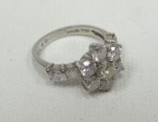 A white gold diamond eleven diamond floral-cluster ring including two diamonds to each shoulder, 6.