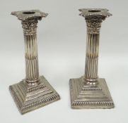 A pair of silver square based Corinthian-column candle-holders, London 1896 (weighted)
