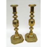 A pair of brass candle-holders 'THE QUEEN OF DIAMONDS', 29cms high