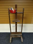 A vintage floor standing wooden easel, 159cms; together with a collection of vintage paint-brushes