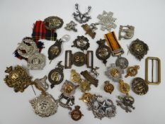 A quantity of regimental badges and reproduction South Africa Medal