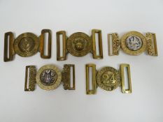 Five regimental belt buckles