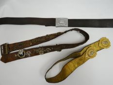 A quantity of belts to include one adorned with regimental cap badges etc.