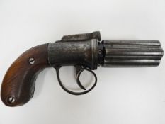 A pepperbox pistol with foliate engraving and wooden handle on replacement screws