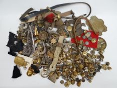 A large quantity of buttons, badges and metal helmet and uniform fittings