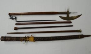 Two wooden swagger sticks, another leather together with three reproduction edged weapons