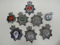 Eight police helmet plates