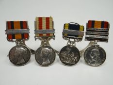 Four Victorian medals with hallmarked silver (Birmingham, 1916) menu holder stands attached to their